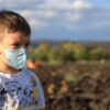 boy in white and blue crew neck shirt with white and blue pacifier